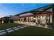 Outdoor living with an expansive backyard featuring an outdoor kitchen, covered seating, and lush lawn at 515 Serenity Point Dr, Henderson, NV 89012