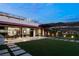 A luxurious outdoor area with a plush lawn, outdoor seating, and sleek walkways at 515 Serenity Point Dr, Henderson, NV 89012