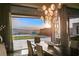 Dining room with stunning sunset views, modern lighting, and an open layout to the outdoor area at 515 Serenity Point Dr, Henderson, NV 89012