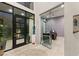 Bright foyer with black-framed glass doors and modern art sculpture creates an inviting entry at 515 Serenity Point Dr, Henderson, NV 89012