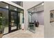 Grand foyer with glass doors, tile flooring, and modern sculpture centerpiece at 515 Serenity Point Dr, Henderson, NV 89012