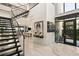 Spacious foyer with a modern staircase, artwork, and an open floor plan at 515 Serenity Point Dr, Henderson, NV 89012