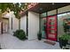 Contemporary home's front entrance with a red door, desert landscaping, and modern architectural design at 515 Serenity Point Dr, Henderson, NV 89012