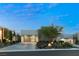 Contemporary home featuring a modern design with a three-car garage, lush landscaping, and elegant stone driveway at 515 Serenity Point Dr, Henderson, NV 89012