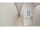 Bright hallway with sleek tile flooring, modern artwork, and neutral color palette at 515 Serenity Point Dr, Henderson, NV 89012