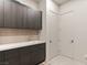 Well-organized laundry room featuring modern cabinetry and ample counter space at 515 Serenity Point Dr, Henderson, NV 89012