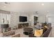 Relaxing living room with wet bar, plush seating, modern entertainment center, and patterned wall coverings at 515 Serenity Point Dr, Henderson, NV 89012