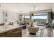 Open concept living room with modern furnishings, chandelier, and sliding glass doors with mountain views at 515 Serenity Point Dr, Henderson, NV 89012
