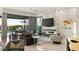 Modern living room featuring a fireplace, large television, and sliding glass doors to the outdoor area at 515 Serenity Point Dr, Henderson, NV 89012