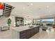 Expansive living space featuring bar, kitchen island, stairs, and open floor plan with mountain views at 515 Serenity Point Dr, Henderson, NV 89012