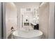 Elegant main bathroom featuring a soaking tub, dual vanities, and neutral tile finishes at 515 Serenity Point Dr, Henderson, NV 89012