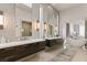 Luxurious main bathroom featuring dual sinks, modern lighting, and a freestanding tub overlooking bedroom at 515 Serenity Point Dr, Henderson, NV 89012