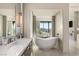 Stylish main bathroom with marble countertops, sleek fixtures, and a soaking tub with views at 515 Serenity Point Dr, Henderson, NV 89012
