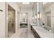 Well-lit main bathroom with dual vanities, a walk-in shower, and a vanity area at 515 Serenity Point Dr, Henderson, NV 89012