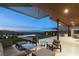 Covered outdoor patio showcasing comfortable seating, outdoor kitchen, and city views at 515 Serenity Point Dr, Henderson, NV 89012