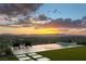 Backyard featuring infinity pool, lounge chairs, turf and dramatic sunset view overlooking the city at 515 Serenity Point Dr, Henderson, NV 89012