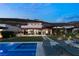 A sleek modern pool and sun loungers overlooking the home's backyard and a mountain backdrop at 515 Serenity Point Dr, Henderson, NV 89012