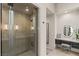 Modern shower with glass doors, neutral tile, and built-in shelving in a luxurious bathroom at 515 Serenity Point Dr, Henderson, NV 89012