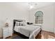 Comfortable bedroom with a stylish bed, side table, and a bright window at 5448 Cove Point Dr, Las Vegas, NV 89130