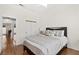 Comfortable bedroom with a stylish bed, mirrored closet, and hardwood floors at 5448 Cove Point Dr, Las Vegas, NV 89130