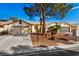 Charming home exterior with a well-maintained yard, mature trees, and two-car garage at 5448 Cove Point Dr, Las Vegas, NV 89130