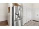 Entry hallway features a stainless steel refrigerator and a series of white doors and neutral flooring at 5448 Cove Point Dr, Las Vegas, NV 89130