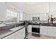 Well-lit kitchen featuring white cabinets, stainless steel appliances, and backsplash at 5448 Cove Point Dr, Las Vegas, NV 89130