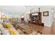 Bright living room features vaulted ceilings, ceiling fan, and wood laminate flooring at 5448 Cove Point Dr, Las Vegas, NV 89130