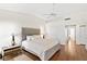 Spacious main bedroom with wood floors, a ceiling fan, and a king bed and a walk-in closet at 5448 Cove Point Dr, Las Vegas, NV 89130