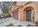 Welcoming home featuring an attached garage, a well-manicured lawn, and convenient walkway at 6007 Sonoma Station Ave, Las Vegas, NV 89139