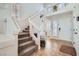 Bright foyer featuring neutral tile flooring, a carpeted staircase, and two front doors at 6007 Sonoma Station Ave, Las Vegas, NV 89139