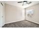 Bright bedroom with a ceiling fan, large window, plush carpeting, and neutral walls creating a relaxing space at 6342 War Emblem Ct, Las Vegas, NV 89141