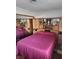 Comfortable bedroom with wall-to-wall cabinets, shelving, and a cozy bed at 6429 Hill View Ave, Las Vegas, NV 89107