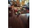 Cozy living room with hardwood floors, colorful rug, comfortable seating, and bookshelf at 6429 Hill View Ave, Las Vegas, NV 89107