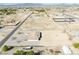 Wide aerial shot of a property with a house, adjacent flat land, and surrounding neighborhood, offering a sense of community at 660 Indian Rd, Pahrump, NV 89048