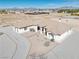Single-story home with neutral stucco, desert landscaping, and a circular gravel driveway at 660 Indian Rd, Pahrump, NV 89048