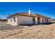 An open back patio with decorative supports runs along the back of the desert home at 660 Indian Rd, Pahrump, NV 89048