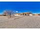 Single-story stucco home with gravel landscaping and a circular driveway leading to the arched front entry at 660 Indian Rd, Pahrump, NV 89048