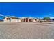 Expansive single-story home with a gravel driveway and well-maintained desert landscaping at 660 Indian Rd, Pahrump, NV 89048
