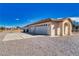 Spacious three-car garage with concrete driveway, neutral stucco, and desert landscape at 660 Indian Rd, Pahrump, NV 89048