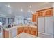 Charming kitchen features white appliances, tile countertops, and light wood cabinets at 660 Indian Rd, Pahrump, NV 89048