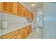 Bright laundry room features tile floors, wood cabinets, white countertop and a washer and dryer at 660 Indian Rd, Pahrump, NV 89048