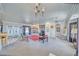 Open living room with a fireplace, ceiling fans, and large windows for natural light at 660 Indian Rd, Pahrump, NV 89048