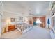 Spacious main bedroom with plush carpet, ceiling fan, and bay windows with decorative curtains at 660 Indian Rd, Pahrump, NV 89048