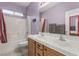 Bathroom with a large double vanity, decorative mirror, shower, and lavendar walls at 682 Baffin Island Rd, Henderson, NV 89011