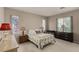 Cozy bedroom with patterned bedding, two windows with patterned coverings, and neutral carpet at 682 Baffin Island Rd, Henderson, NV 89011