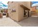Beige two-story townhouse with ample parking space and secure gated entry at 682 Baffin Island Rd, Henderson, NV 89011
