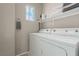 Efficient laundry area with washer, dryer, storage shelf, and natural light at 682 Baffin Island Rd, Henderson, NV 89011