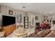 Tile-floored living room features a TV, fireplace, and dining area at 682 Baffin Island Rd, Henderson, NV 89011