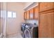 Convenient laundry room features modern appliances and storage cabinets, making laundry tasks a breeze at 694 Tomscott Ave, Henderson, NV 89052